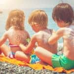 3 Kids Applying Sunscreen