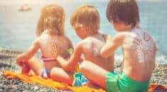 3 Kids Applying Sunscreen