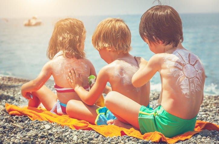 3 Kids Applying Sunscreen