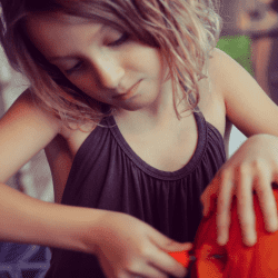 Girl Carving Pumpkin